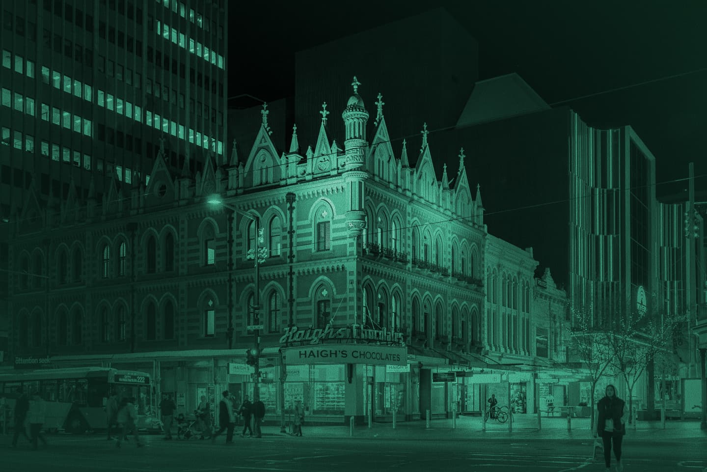 Night street corner of Haigh’s Chocolates historic building in Adelaide, teal tint