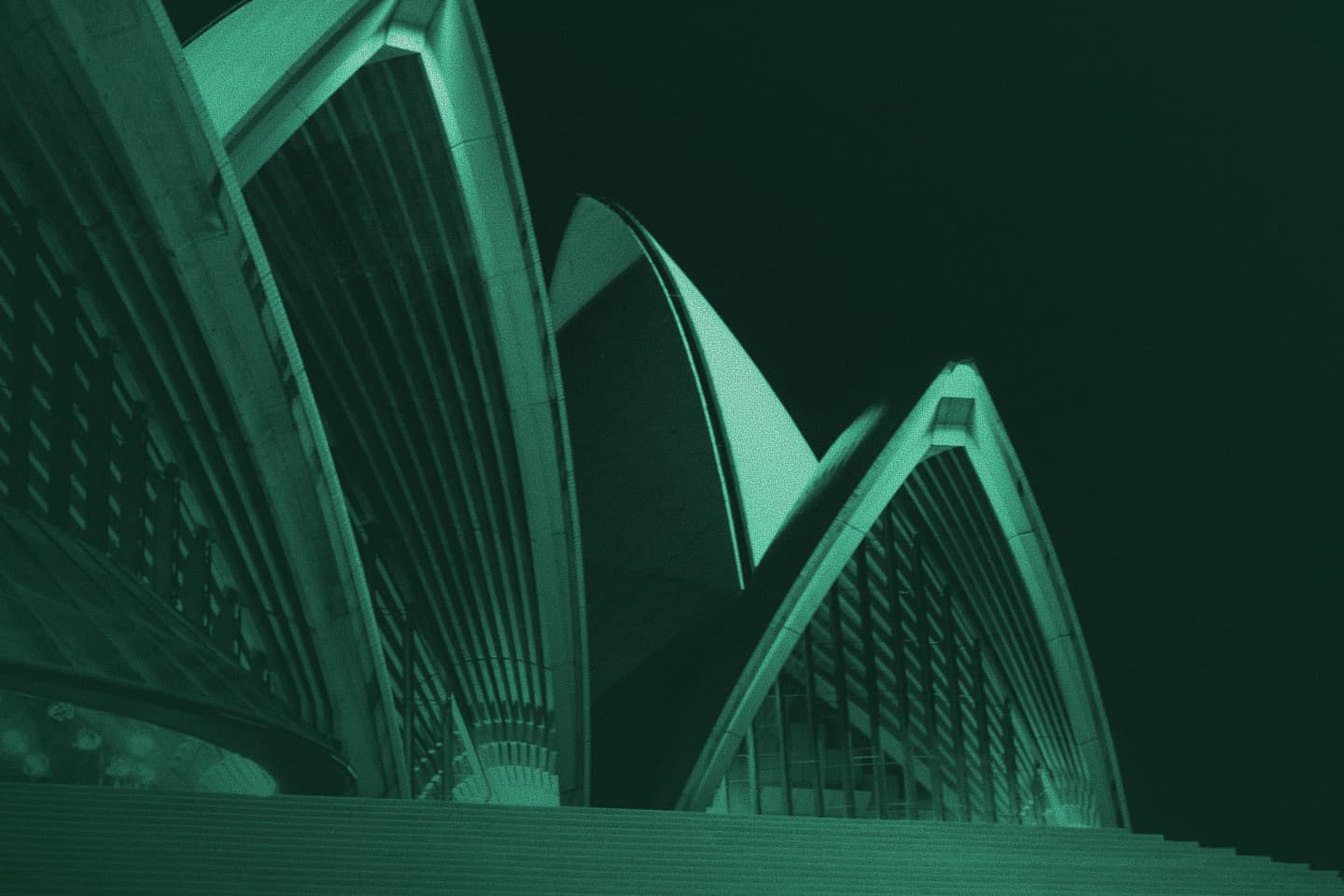 Low-angle view of the Sydney Opera House sails with a grainy teal colour filter